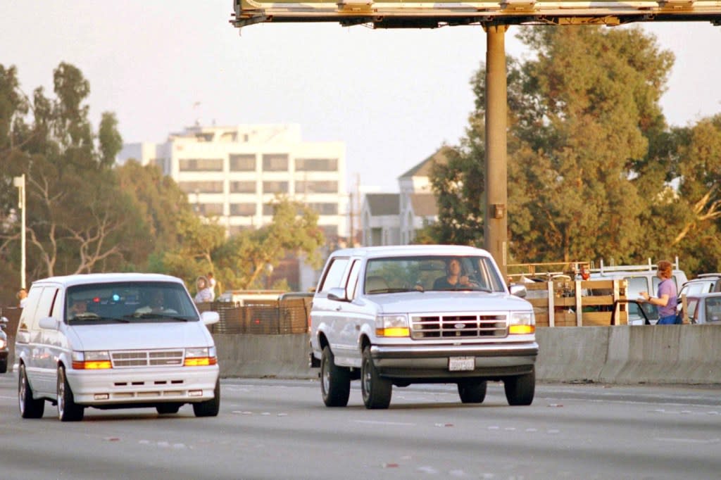 Al Cowlings, with O.J. Simpson hiding, drives a white Ford Bronco as they lead police on a two-county chase along the northbound 405 Freeway towards Simpson’s home, June 17, 1994, in Los Angeles. (AP Photo/Lois Bernstein, File)