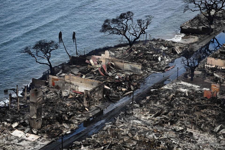 An aerial image taken on August 10, 2023 shows destroyed homes and buildings burned to the ground in Lahaina in the aftermath of wildfires in western Maui, Hawaii. At least 36 people have died after a fast-moving wildfire turned Lahaina to ashes, officials said August 9, 2023 as visitors asked to leave the island of Maui found themselves stranded at the airport. The fires began burning early August 8, scorching thousands of acres and putting homes, businesses and 35,000 lives at risk on Maui, the Hawaii Emergency Management Agency said in a statement. (Photo by Patrick T. Fallon / AFP) (Photo by PATRICK T. FALLON/AFP via Getty Images)