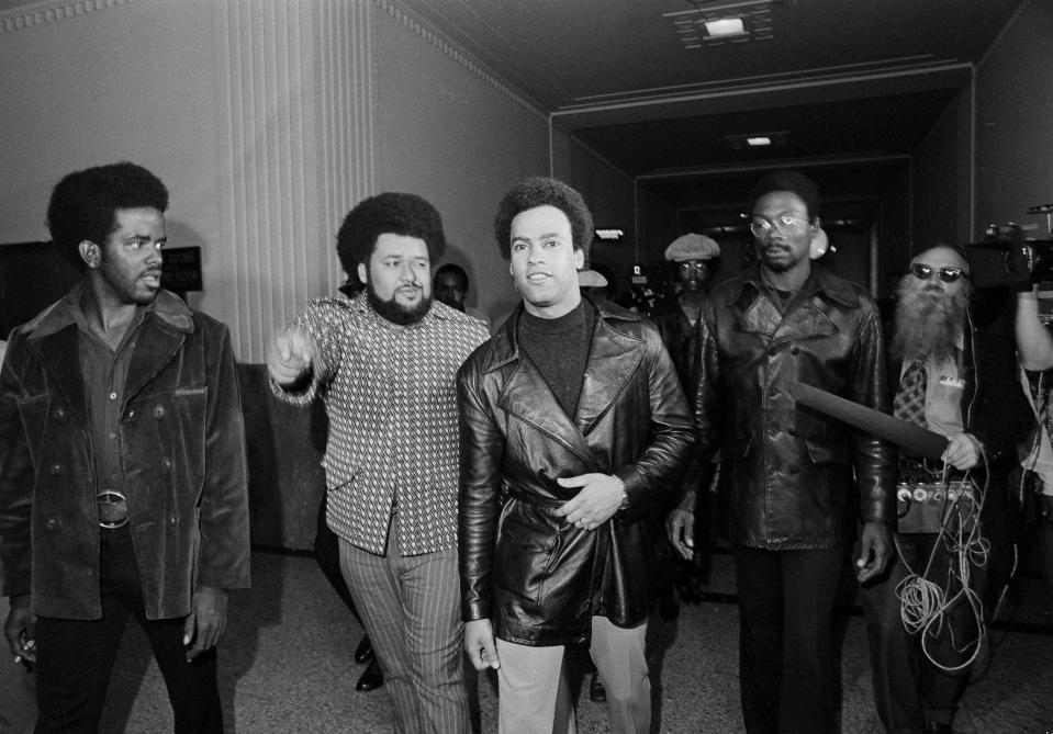 FILE - In this Oct. 13, 1971, file photo, accompanied by his bodyguard, Robert Leonard Bay, left, Huey Newton, co-founder of the Black Panther Party, leaves the Alameda County Courthouse, after his third trial in connection with the death of a policeman. John Frey, an Oakland police officer who died of gunshot wounds in 1967 after pulling Newton over. Newton denied shooting Frey but was convicted of voluntary manslaughter in 1968 Newton's conviction, but was overturned two years later. The case spurred a "Free Huey" campaign. (AP Photo/Rusty Kennedy, File)