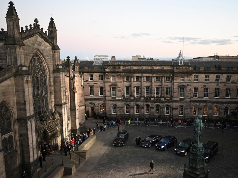 Members of the public wait outside St Giles' Cathedral in Edinburgh, Scotland