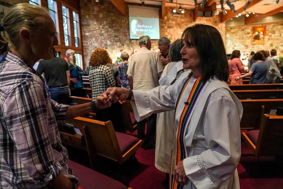 Pastor Tracy Beadle fist-bumps a congregation member during a Sunday service at Westlake United Methodist Church on May 5, 2024, just days after United Methodists voted at a General Conference to approve inclusive rules about sexuality.