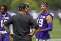 Minnesota Vikings coach Mike Zimmer, left, listens to wide receiver Adam Thielen (19) during NFL football training camp Wednesday, July 28, 2021, in Eagan, Minn. (AP Photo/Bruce Kluckhohn)