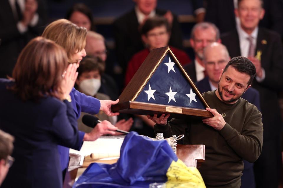 President of Ukraine Volodymyr Zelensky receives an American flag from U.S. Speaker of the House Nancy Pelosi (D-CA) and Vice President Kamala Harris as he addresses a joint meeting of Congress in the House Chamber of the U.S. Capitol on December 21, 2022 in Washington, DC (Getty Images)