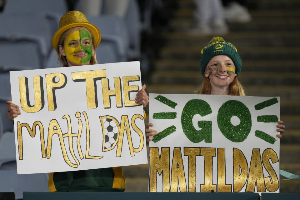 Australia fans hold posters on the stands before the Women's World Cup soccer match between Australia and Ireland at Stadium Australia in Sydney, Australia, Thursday, July 20, 2023. Australia's team captain Kerr will miss their her team's World Cup opening match due to an injury. (AP Photo/Mark Baker)