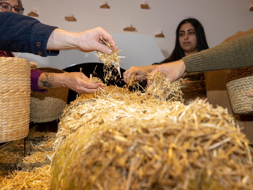 Family members place straw on the deceased body in this mock ceremony.