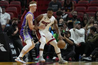 Miami Heat guard Kyle Lowry, right, drives up against Sacramento Kings guard Kevin Huerter during the first half of an NBA basketball game, Wednesday, Nov. 2, 2022, in Miami. (AP Photo/Wilfredo Lee)