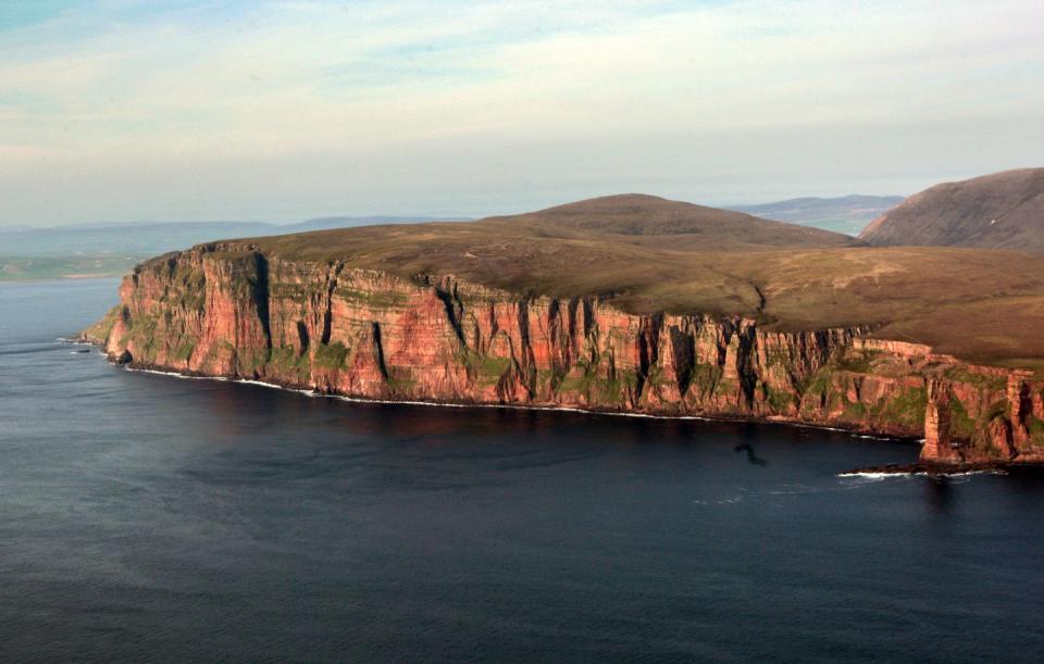 <p>Take a ferry from the Scottish mainland to visit Hoy, which has dramatic coastlines. Hoy has a huge and varied bird life, along with several landmarks like the Dwarfie Stane, a rock-cut tomb. Fun fact: The 1984 video for the Eurythmics' "Here Comes the Rain Again" was shot here. </p>