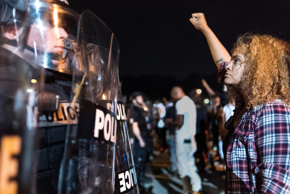 Police officers face off with protesters on the I-85 during protests.