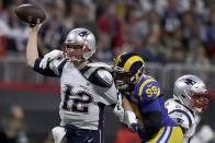 <p>New England Patriots’ Tom Brady (12) passes under pressure form Los Angeles Rams’ Aaron Donald (99) during the first half of the NFL Super Bowl 53 football game Sunday, Feb. 3, 2019, in Atlanta. (AP Photo/Carolyn Kaster) </p>