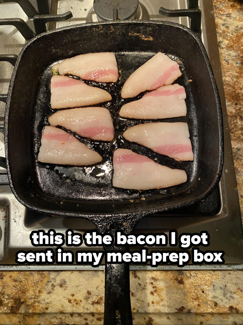 fatty bacon in a pan and the words "This is the bacon I got sent in my meal-prep box"