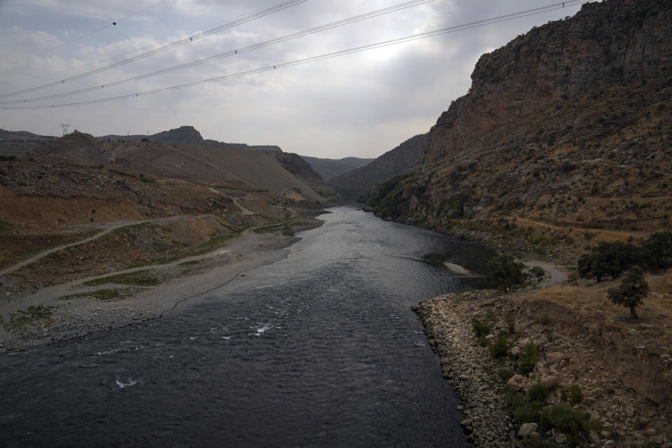 Tigris river flows from the Ilisu Dam reservoir is seen in Mardin province, Turkey, Tuesday, Oct. 18, 2022. Before Turkey began operating the dam in May 2020, all the waters of Tigris River flowed into Iraq. Now how much water comes down depends on Ankara's consideration of Iraq's month-to-month requests for a minimum flow, weighed against Turkey's own needs. (AP Photo/Khalil Hamra)