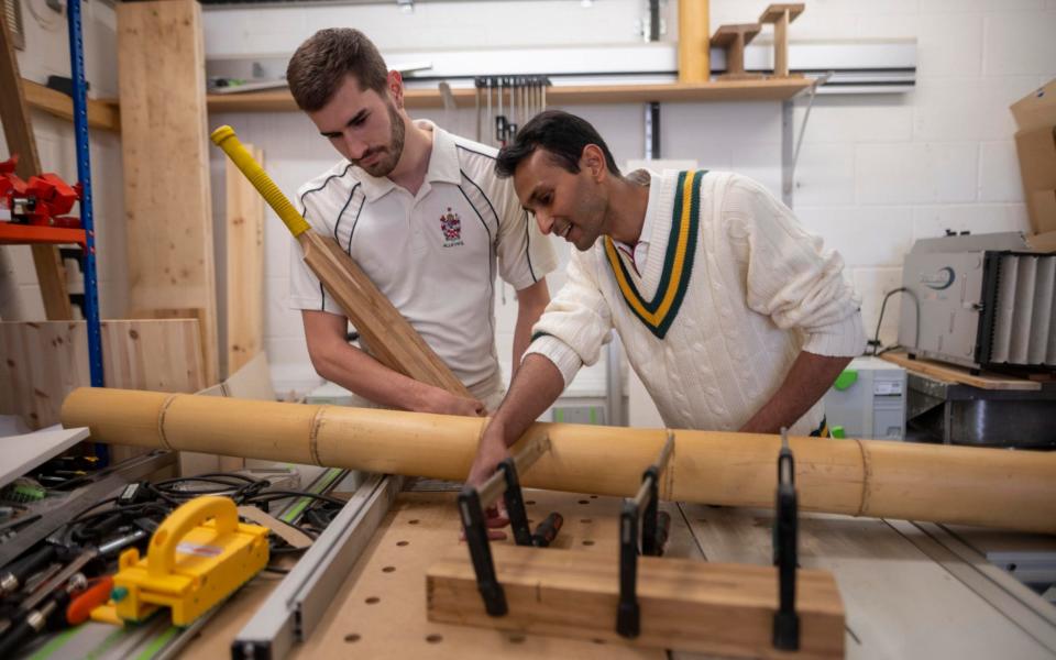 Dr Darshil Shah with Ben Tinkler-Davies in a workshop where the bamboo is made into blocks before it was sent to the cricket bat maker - Paul Grover for the Telegraph