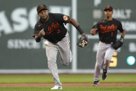 Baltimore Orioles third baseman Maikel Franco can't handle a single by Boston Red Sox's Enrique Hernandez as shortstop Richie Martin (1) watches during the first inning of a baseball game at Fenway Park, Friday, Aug. 13, 2021, in Boston. (AP Photo/Elise Amendola)