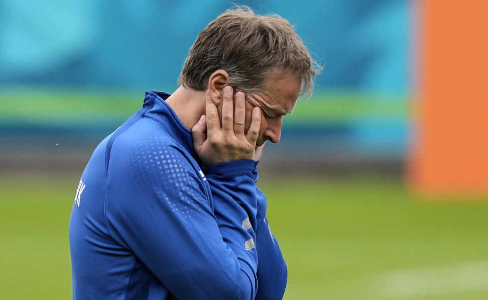 Denmark's manager Kasper Hjulmand, left, reacts at the training ground during a training session of Denmark's national team in Helsingor, Denmark, Monday, June 14, 2021. It is the first training of the Danish team since the Euro championship soccer match against Finland when Christian Eriksen collapsed last Saturday. (AP Photo/Martin Meissner)