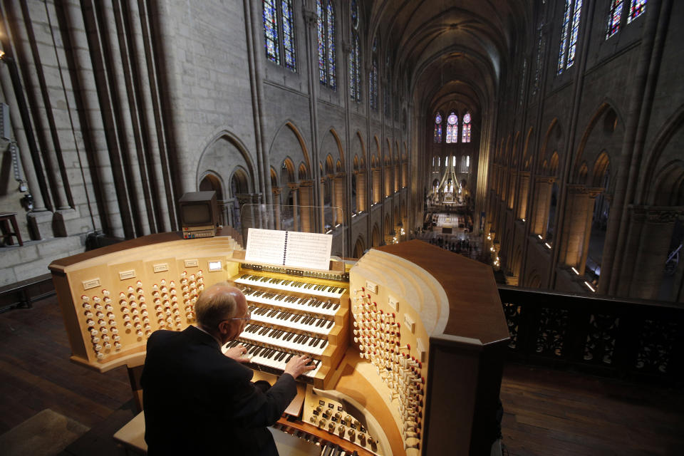 In this Thursday, May 2, 2013 photo, Philippe Lefebvre, 64, plays the organ at Notre Dame cathedral in Paris. The restoration of Notre Dame hits a milestone Friday, Dec. 8, 2023: one year until the cathedral reopens its huge doors to the public. (AP Photo/Christophe Ena)