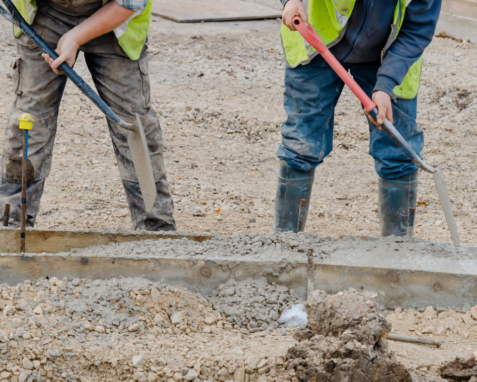 construction workers laying concrete