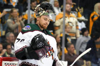 Arizona Coyotes goaltender Karel Vejmelka looks at his glove hand after allowing a goal by Pittsburgh Penguins' Kris Letang during the second period of an NHL hockey game in Pittsburgh, Tuesday, Jan. 25, 2022. (AP Photo/Gene J. Puskar)