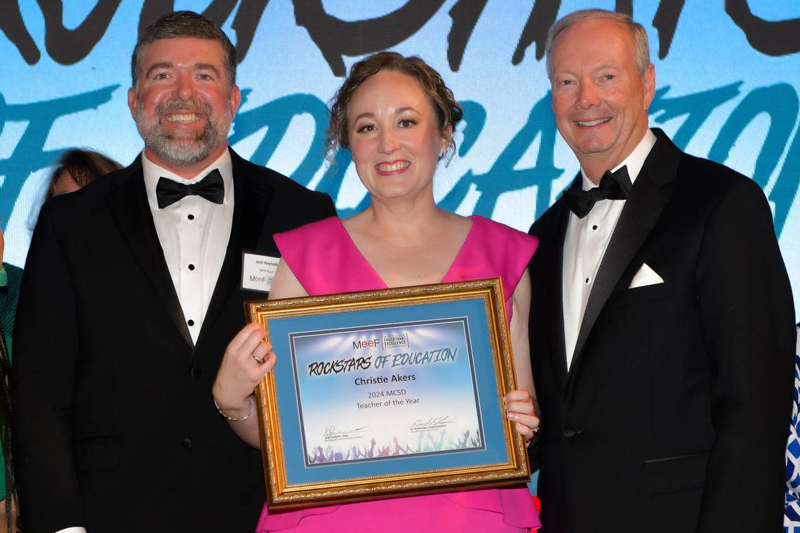 Muscogee County School District 2024 Teacher of the Year Christie Akers of Northside High School poses with her certificate along with Muscogee Educational Excellence Foundation chairman Josh Reynolds, left, and MCSD superintendent David Lewis during MEEF’s Teacher of the Year gala May 9, 2024, in the Columbus Convention & Trade Center.