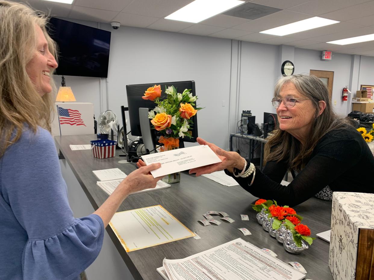 A Great Falls voter drops off ballots at the Cascade County Election Office during library mill levy election in June, 2023.