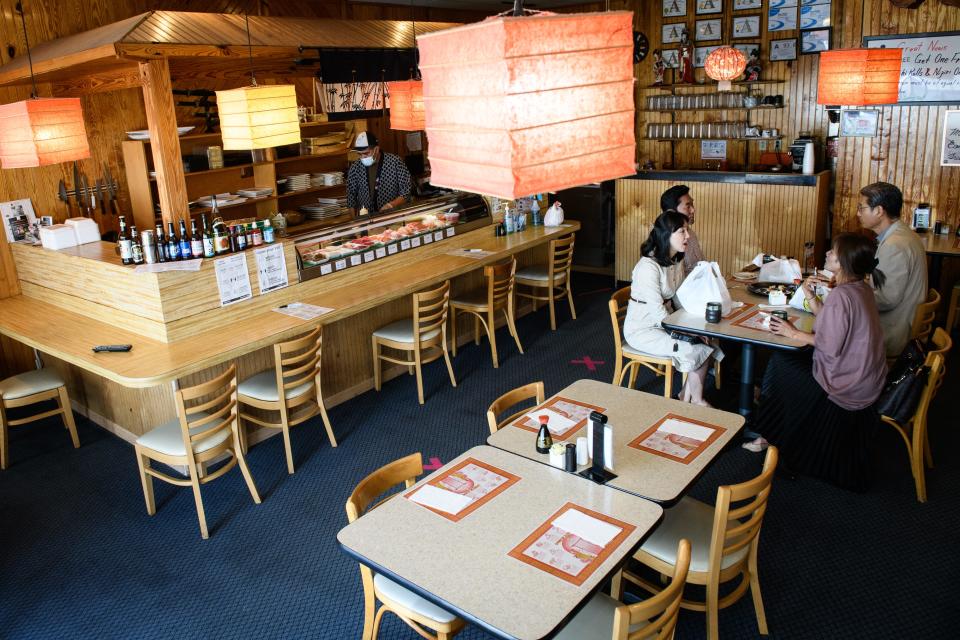 Customers sit and chat after finishing lunch at Sakura in the Cliffdale Square shopping plaza on Wednesday, May 5, 2021.