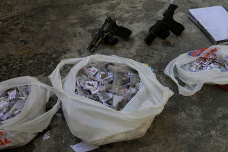 Drugs and guns seized from suspects arrested after they took a family hostage during violent clashes with Brazilian Army soldiers in Alemao slums complex, in Rio de Janeiro, Brazil August 20, 2018. REUTERS/Ricardo Moraes