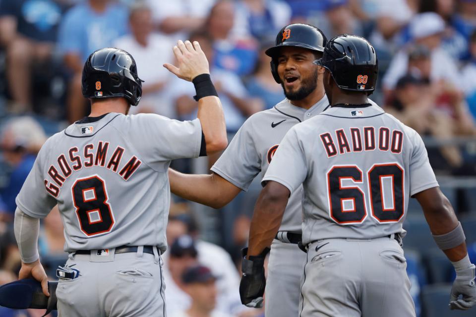 Detroit Tigers' Jeimer Candelario, center, is congratulated at home plate by Robbie Grossman (8) and Akil Baddoo (60) after hitting a three-run home run during the fourth inning of a baseball game against the Kansas City Royals at Kauffman Stadium in Kansas City, Mo., Saturday, July 24, 2021.