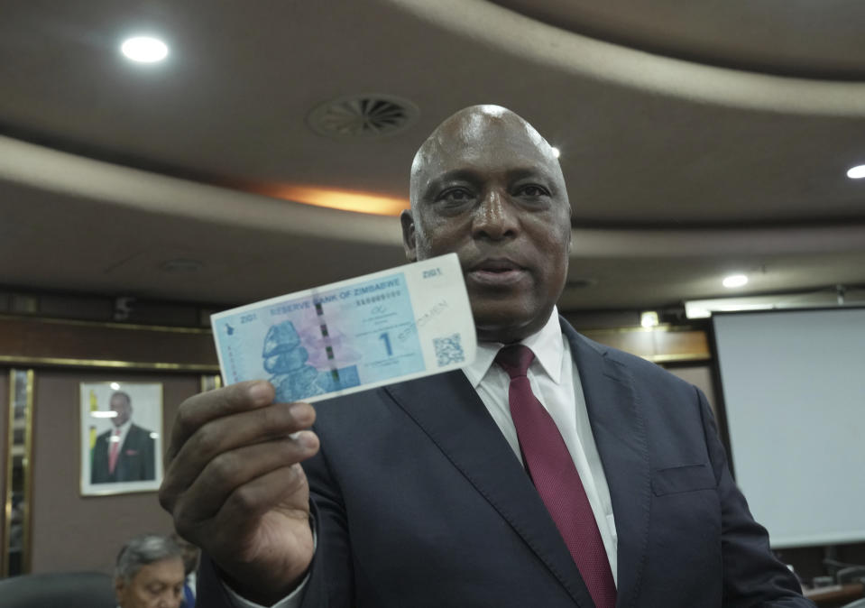 Reserve Bank of Zimbabwe Governor, John Mushayavanhu holds a sample of the country's new currency at a press briefing in Harare, Friday, April 5, 2024.Zimbabwe on Friday launched a new currency to replace a local unit that in recent months has been battered by depreciation, and in some instances rejected by the population, and authorities hope the new measure will arrest the currency crisis underlining the country's years long economic troubles. (AP Photo/Tsvangirayi Mukwazhi)