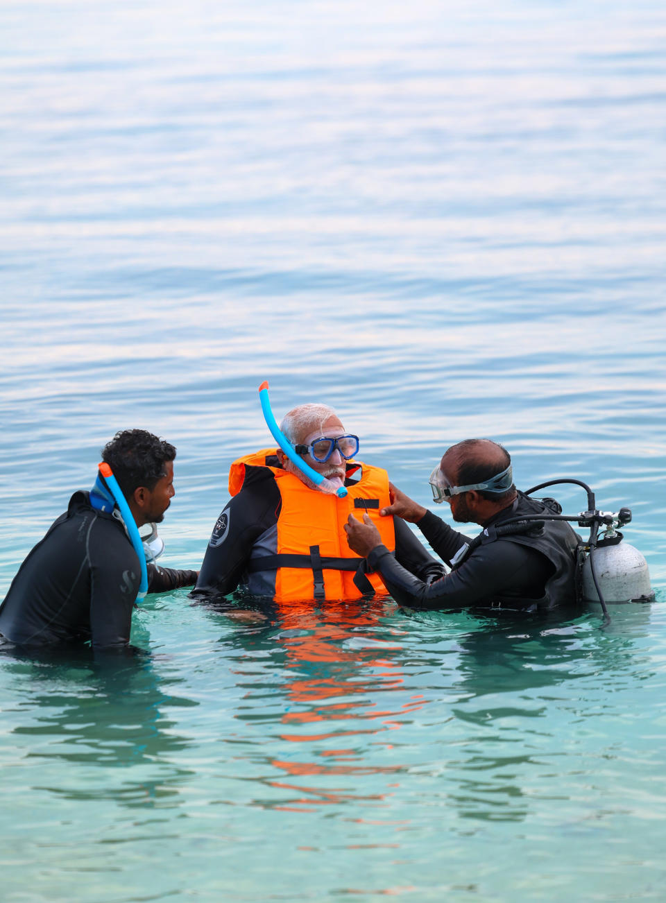 In this photograph released on Indian Prime Minister Narendra Modi's social media platform X on Jan.4, 2024, Modi, center, tries snorkelling at a beach in Lakshadweep, India. Relationship between India and the Maldives is facing challenges after officials in the tiny island nation made derogatory remarks against Prime Minister Narendra Modi’s posts that promoted the pristine beaches of India’s Lakshadweep archipelago. (Narendra Modi's social media platform X via AP)