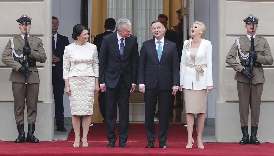 Lithuanian First Lady Diana Nausediene, Lithuanian President Gitanas Nauseda, his Polish counterpart Andrzej Duda and Poland's First Lady Agata Kornhauser-Duda attend a military welcome ceremony at the presidential Palace in Warsaw, Poland, Tuesday, July 16, 2019.(AP Photo/Czarek Sokolowski)