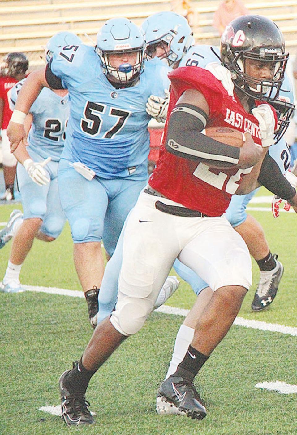 Bartlesville High School's Colton Green, left, gives heavy backside pursuit to a Tulsa East Central High School ballcarrier during Green's prep playing days.