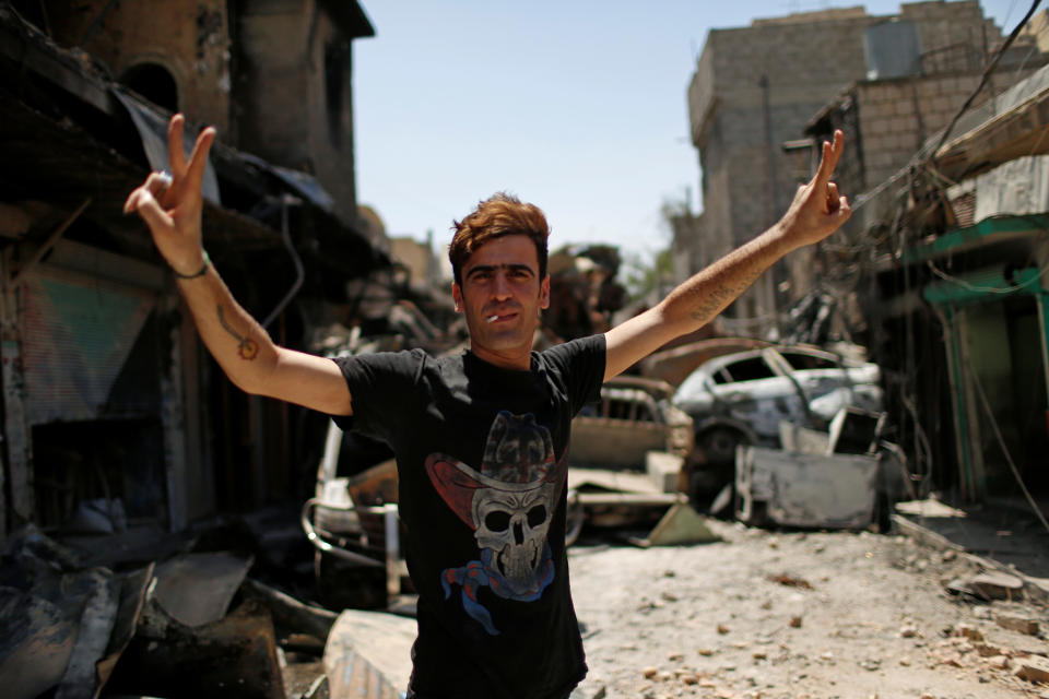 An Iraqi Federal Police member gestures on the frontline