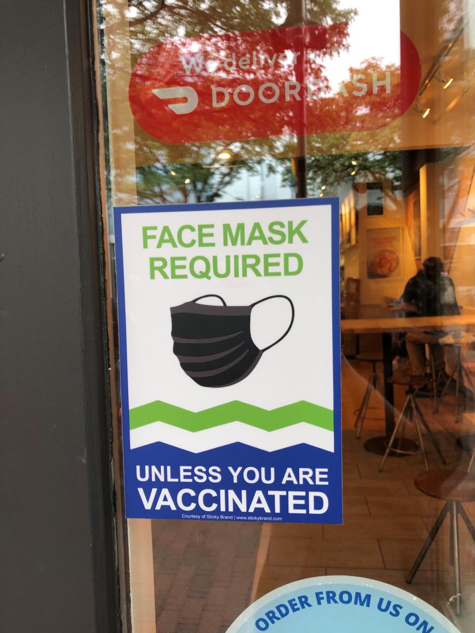 A store on the Church Street Marketplace in Burlington announces its mask policy on Saturday, Aug. 28, 2021.