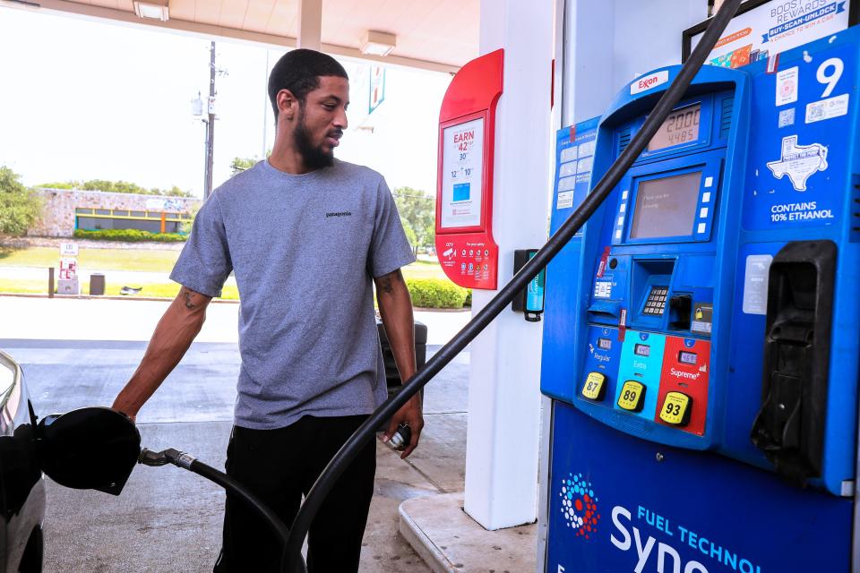 Austin resident Chris O'Neal puts gas in his vehicle Monday at an Exxon station on William Cannon Drive. O'Neal said he had been driving around looking for the lowest prices. "I just came from another station where gas was 50 cents more a gallon for premium," he said.