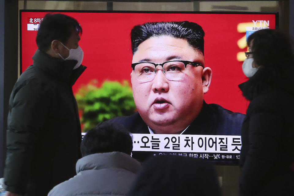 People walk by a TV screen showing North Korean leader Kim Jong Un during a ruling party congress, at the Seoul Railway Station in Seoul, South Korea, Wednesday, Jan. 6, 2021. Kim opened his country's first ruling party congress in five years with an admission of policy failures and a vow to set new developmental goals, state media reported Wednesday. (AP Photo/Ahn Young-joon)
