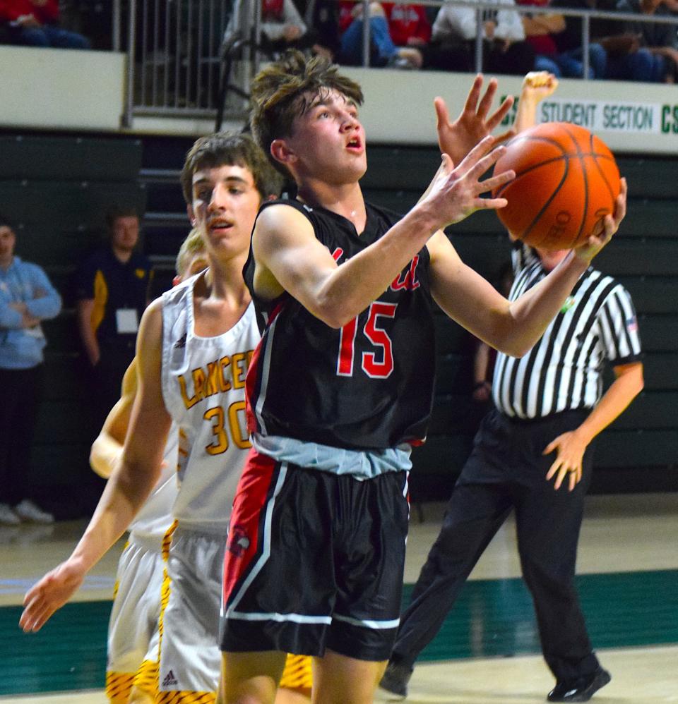 Hiland freshman Alex Miller goes up for a shot in front of Federal Hocking defender Scotty Balch.