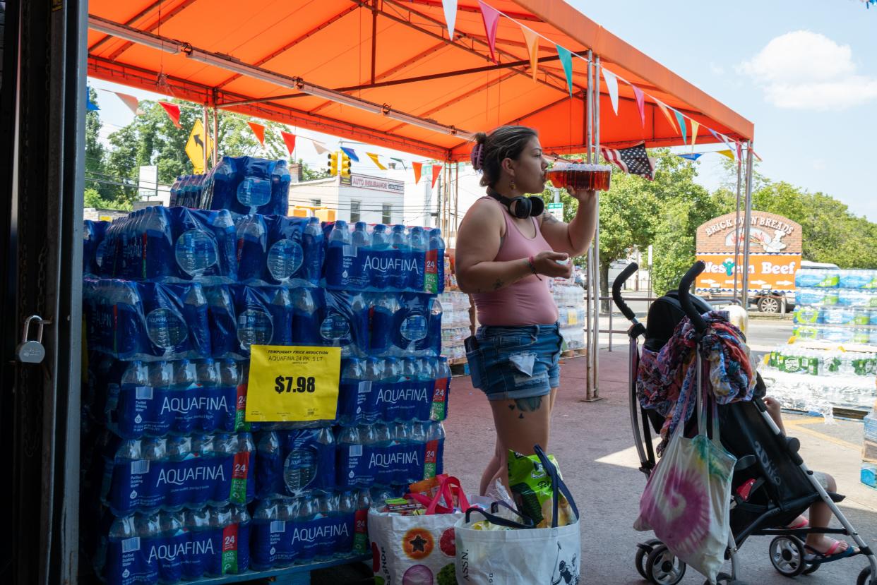 Water is displayed for sale outside of a Staten Island grocery store on a hot afternoon on Tuesday.