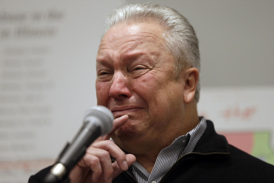 Joe Iacono, right, pauses as he comforted by attorney Jeff Anderson during a news conference, Wednesday, March 20, 2019, in Chicago. Advocates for clergy abuse victims say their list of 395 priests or lay people in Illinois who have been publicly accused of sexually abusing children is far more extensive than the names already released by the state's six dioceses. (AP Photo/Kiichiro Sato)