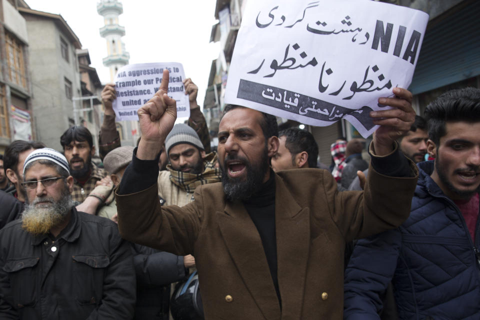 Supporters of Jammu Kashmir Liberation Front (JKLF) shout freedom slogans during a protest in Srinagar, Indian controlled Kashmir, Friday, March 1, 2019. India has banned Jama'at-e-Islami, a political-religious group in Kashmir, in a sweeping and ongoing crackdown against activists seeking the end of Indian rule in the disputed region amid the most serious confrontation between India and Pakistan in two decades. Placard in Urdu reads "we reject terrorism by National Investigation Agency ( NIA)." (AP Photo/Dar Yasin)