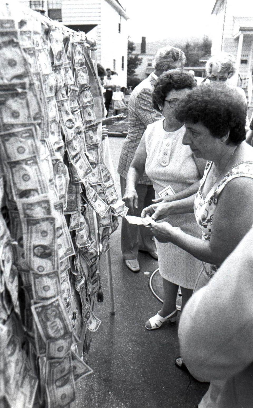 San Rocco Days procession in Aliquippa on Aug. 19, 1984. Aliquippians pin money on a banner carried behind the San Rocco statue.