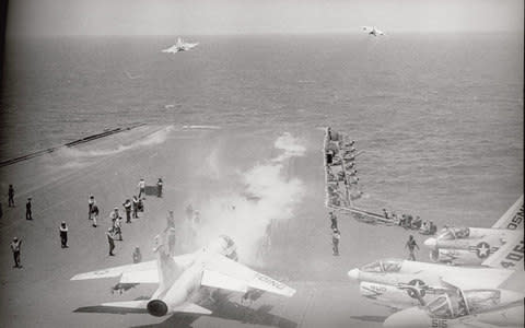 US navy jets take off from the deck of USS Constellation south-east of Saigon, on bombing missions during the Vietnam war, 1972 - Credit: &#160;Bettmann