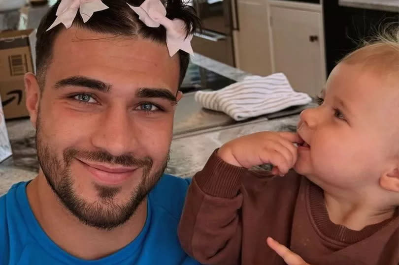 Tommy Fury with bows in his hair