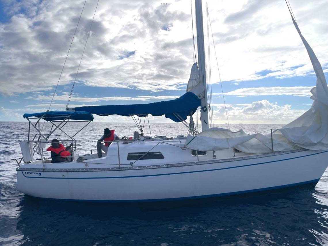 Several people from Haiti sit wearing life jackets on board a sailboat that U.S. Customs and Border Protection agents say is a migrant smuggling vessel that they stopped off Lake Worth Tuesday, Jan. 31, 2023.