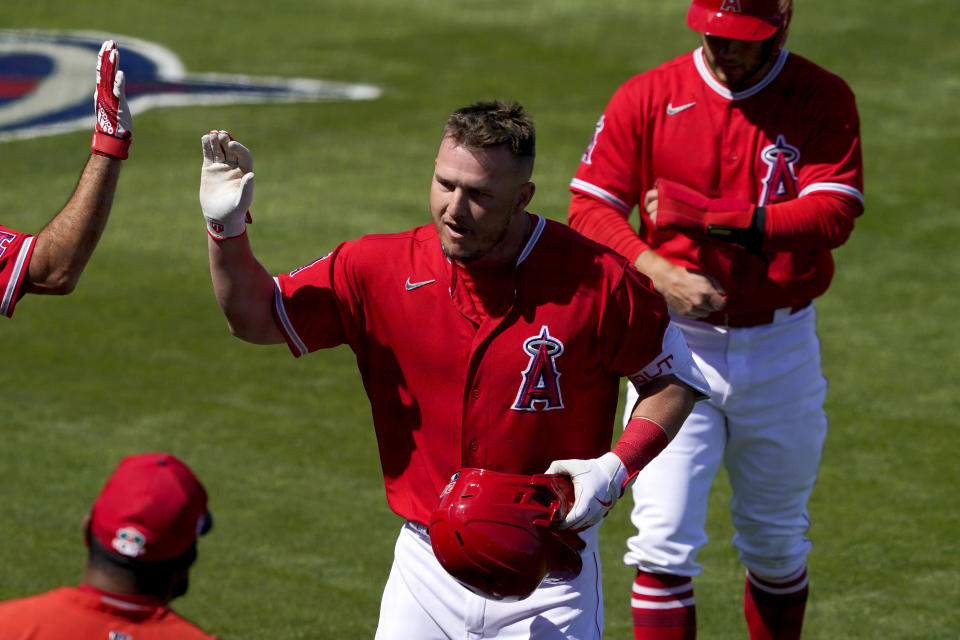 Los Angeles Angels' Mike Trout celebrate his two run home run during the first inning of a spring training baseball game against the San Francisco Giants, Thursday, March 11, 2021, in Tempe, Ariz. (AP Photo/Matt York)