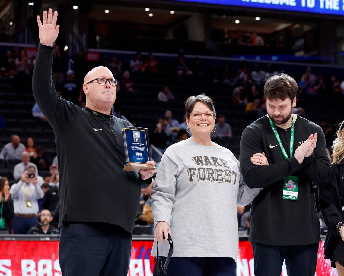 Wake Forest coach Steve Forbes acknowledges the crowd while standing with wife Johnetta and son Chris after the Forbes family was awarded the Bob Bradley Award before the Demon Deacons’’ game against Notre Dame in the second round of the 2024 ACC Men’s Basketball Tournament at Capital One Arena in Washington, D.C., Wednesday, March 13, 2024. Johnetta is recovering from a stroke that occurred in August.