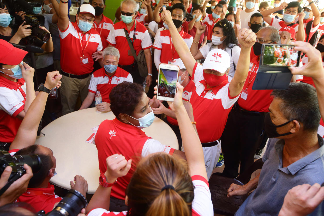 SINGAPORE - JULY 05:  Secretary-General of the Progress Singapore Party (PSP), Dr Tan Cheng Bock (R) reacts as Lee Hsien Yang (seated) looks on during a door stop interview during the PSP campaign walkabout ahead of the general election on July 5, 2020 in Singapore. Singapore will go to the polls on July 10 as the ruling party, PeopleÕs Action Party seeks a fresh mandate amid the coronavirus (COVID-19) pandemic. As of July 5, the total number of COVID-19 cases in the country stands at 44,800.  (Photo by Suhaimi Abdullah/Getty Images)