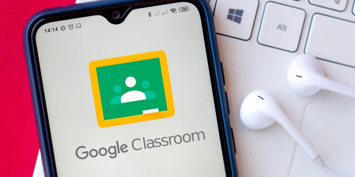 Google Classroom app on an Android phone resting on a Mac laptop