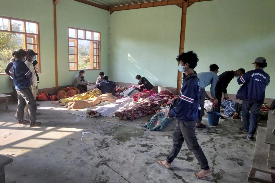 People clean the victims of airstrikes being shrouded in blankets at a building in Kanan village, Khampat town in Sagaing region on Sunday, Jan.7, 2024. Airstrikes by Myanmar’s military on a village under the control of the pro-democracy resistance in the country’s northwest are reported to have killed at least 17 civilians, including nine children. (AP Photo)