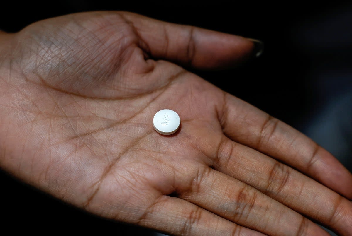 A patient holds a mifepristone pill, one of two drugs in a two-drug regimen for a medication abortion, the most common form of abortion care in the US  (REUTERS)