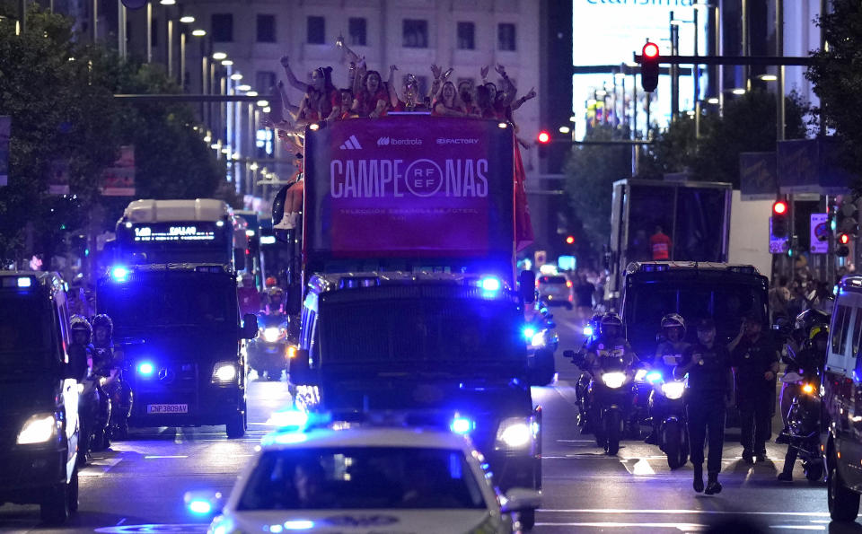 Spain's Women's World Cup soccer team celebrate on top of bus as they arrive in Madrid, Spain, Monday, Aug. 21, 2023. Spain beat England in Sydney Sunday to win the Women's World Cup soccer final. (AP Photo/Manu Fernandez)