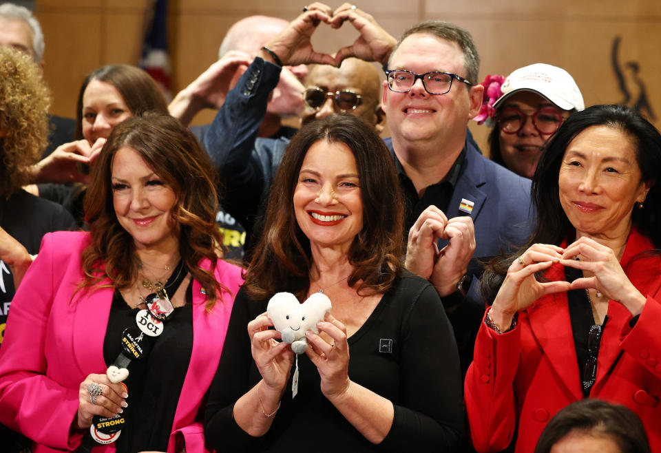 LOS ANGELES, CALIFORNIA - NOVEMBER 10: SAG-AFTRA President Fran Drescher (C), SAG-AFTRA Secretary-Treasurer Joely Fisher (L), SAG-AFTRA National Executive Director Duncan Crabtree-Ireland (UPPER R) and other union members pose for a group photo at a press conference discussing their strike-ending deal with the Hollywood studios on November 10, 2023 in Los Angeles, California. A tentative labor agreement has been reached between the actors union and the Alliance of Motion Picture and Television Producers (AMPTP) with the strike completed after 118 days, the longest strike in the history of the union. (Photo by Mario Tama/Getty Images)